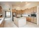 Large kitchen featuring wood cabinets, island cooktop, and adjoining breakfast nook at 12291 S Critchell Ln, Littleton, CO 80127