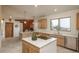 Open kitchen with wood cabinets, center island cooktop, and stainless steel appliances at 12291 S Critchell Ln, Littleton, CO 80127