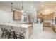 Bright kitchen with custom wood cabinets, stainless appliances, and breakfast bar seating at 12291 S Critchell Ln, Littleton, CO 80127