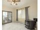 Bright living room with pellet stove, light tile flooring, and sliding glass doors to deck at 12291 S Critchell Ln, Littleton, CO 80127