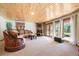 Cozy living room featuring a knotty pine ceiling and fireplace at 12291 S Critchell Ln, Littleton, CO 80127