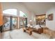 A cozy living room with a hardwood floor, an open concept layout, and access to a deck at 12291 S Critchell Ln, Littleton, CO 80127