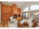 Living room showcasing a custom fireplace, hardwood floors, and access to an outdoor deck at 12291 S Critchell Ln, Littleton, CO 80127