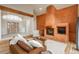 Living room featuring a unique fireplace, wood beam, and an open concept floor plan at 12291 S Critchell Ln, Littleton, CO 80127