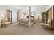 Serene bedroom with a luxurious four-poster bed, soft lighting, and ample space for a relaxing retreat at 12291 S Critchell Ln, Littleton, CO 80127