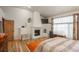 Spacious main bedroom with fireplace and hardwood floors at 12291 S Critchell Ln, Littleton, CO 80127