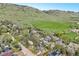 Gorgeous aerial view of neighborhood property and rolling green fields with a mountain backdrop at 805 Union Ave, Boulder, CO 80304