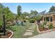 A serene backyard with stone pathway, seating, and manicured lawn with landscaping at 805 Union Ave, Boulder, CO 80304