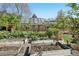Backyard with raised garden beds, brick home, and solar panels at 805 Union Ave, Boulder, CO 80304
