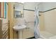 Bathroom with pedestal sink, bathtub, and tiled walls and trim at 805 Union Ave, Boulder, CO 80304