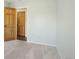 Bedroom featuring neutral carpet, walls, baseboards, and wood doors at 805 Union Ave, Boulder, CO 80304