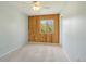 Cozy bedroom with wood accent wall, neutral carpet and paint, and bright window view at 805 Union Ave, Boulder, CO 80304