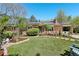 Charming brick home with solar panels, a well-manicured lawn, and a cozy front patio seating area at 805 Union Ave, Boulder, CO 80304