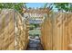 The front yard is shown through the wooden fence and pergola at 805 Union Ave, Boulder, CO 80304