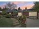 Brick home with solar panels, landscaped yard, and flagstone walkway leading to the front door at dusk at 805 Union Ave, Boulder, CO 80304