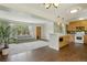Living room adjacent to modern kitchen with hardwood floors and large window with a view of the backyard at 805 Union Ave, Boulder, CO 80304
