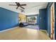 Spacious living room with light wood floors, accent wall, projector, and large window at 805 Union Ave, Boulder, CO 80304