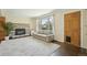 Bright living room features a stone fireplace, hardwood floors, a neutral sofa, and natural light at 805 Union Ave, Boulder, CO 80304