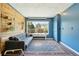 Comfortable living room features blue walls, wood accent wall, area rug, and bright window at 805 Union Ave, Boulder, CO 80304