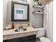 Charming bathroom with a tile countertop, a modern sink, a large mirror, and stylish decor for a clean and inviting space at 2491 S Xanadu Way # A, Aurora, CO 80014