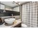 Modern bathroom featuring stylish sink, vanity, and shower with tiled surround at 2491 S Xanadu Way # A, Aurora, CO 80014
