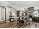 Open dining area with a stone fireplace, modern lighting, and hardwood floors at 2491 S Xanadu Way # A, Aurora, CO 80014