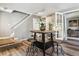 Dining area includes a modern table, wood floors, and French doors leading to another room at 2491 S Xanadu Way # A, Aurora, CO 80014