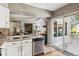 Open kitchen showcasing stainless steel dishwasher, granite countertops and flow into living area at 2491 S Xanadu Way # A, Aurora, CO 80014