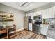 Well-lit kitchen featuring stainless steel appliances and sleek white cabinetry at 2491 S Xanadu Way # A, Aurora, CO 80014