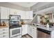 Charming kitchen with stainless appliances, light countertops, and easy access to the laundry area at 2491 S Xanadu Way # A, Aurora, CO 80014