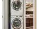 Efficient laundry area with stacked washer and dryer, adjacent to bathroom at 2491 S Xanadu Way # A, Aurora, CO 80014