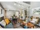 Living room view includes a table with stools, French doors and a comfortable couch at 2491 S Xanadu Way # A, Aurora, CO 80014