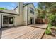 Backyard deck with home exterior, siding and wood stairs to the yard and sliding glass doors at 6414 S Hudson St, Centennial, CO 80121
