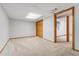 Spacious basement with neutral carpet, bright lighting and trim accents, perfect for storage or finishing at 6414 S Hudson St, Centennial, CO 80121