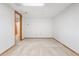 An unfinished basement space with neutral carpet, white walls and ceilings, great for storage and recreation at 6414 S Hudson St, Centennial, CO 80121