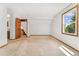 Bright bedroom featuring neutral carpet, window with natural light and a paneled wood door at 6414 S Hudson St, Centennial, CO 80121