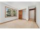 Spacious bedroom boasts two windows, neutral carpet, and wood doors to closet/bathroom at 6414 S Hudson St, Centennial, CO 80121