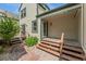 Charming covered front porch with wooden steps and light green siding enhances the home's curb appeal at 6414 S Hudson St, Centennial, CO 80121
