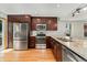Bright kitchen featuring stainless steel appliances, granite countertops, and wood floors at 6414 S Hudson St, Centennial, CO 80121