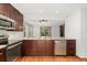 Updated kitchen boasts stainless steel appliances, granite counters, and wood cabinets at 6414 S Hudson St, Centennial, CO 80121