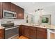 Modern kitchen with stainless steel appliances, granite countertops, and ample cabinet space at 6414 S Hudson St, Centennial, CO 80121
