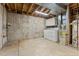Utility room features a washer, dryer, water heater, storage cabinets, and concrete flooring and walls at 6414 S Hudson St, Centennial, CO 80121