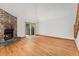 Bright living room features hardwood floors, a stone fireplace, and sliding glass doors at 6414 S Hudson St, Centennial, CO 80121