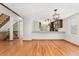 Open floor plan with hardwood floors flowing from the living room into the modern kitchen at 6414 S Hudson St, Centennial, CO 80121