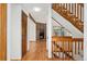Elegant living room with hardwood floors, a stone fireplace, and a staircase at 6414 S Hudson St, Centennial, CO 80121