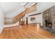 Spacious living room with hardwood floors, stone fireplace, and plenty of natural light at 6414 S Hudson St, Centennial, CO 80121