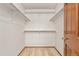 Walk-in closet with carpeted floor and built-in shelving, offering ample storage space at 6414 S Hudson St, Centennial, CO 80121
