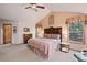 Comfortable main bedroom featuring a vaulted ceiling, natural light, and carpet floors at 19890 Indian Summer Ln, Monument, CO 80132