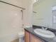 Clean bathroom with a single sink, wood cabinets, and a shower at 14700 E 104Th Ave # 2605, Commerce City, CO 80022