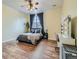 Comfortable bedroom features hardwood floors, large window, and neutral decor at 14700 E 104Th Ave # 2605, Commerce City, CO 80022